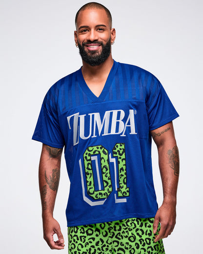 Male model wearing a blue jersey with 'ZUMBA 01' print and paired with green leopard pants.
