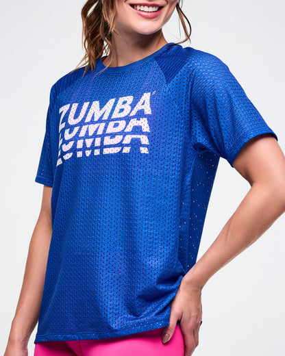 Close-up view showing a female model wearing a blue Zumba mesh top. 