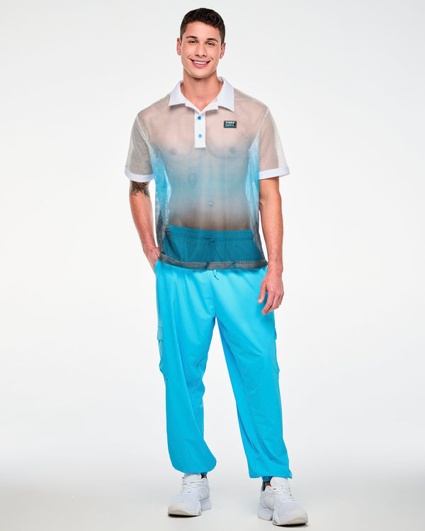 Male model with one hand in his pocket, wearing the white-to-blue mesh polo with a white collar and light blue buttons, paired with aqua blue cargo pants.