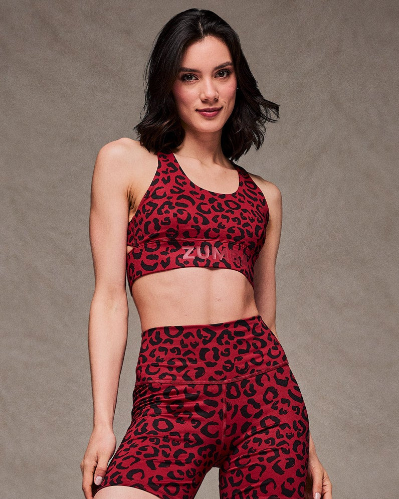 Close-up view of a female model in the dark red leopard print longline bra with matching biker shorts