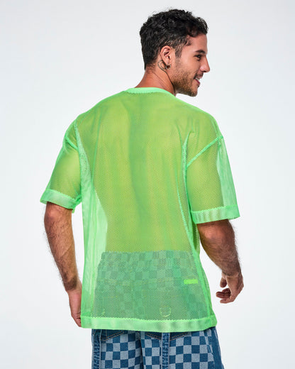 Back view of a male model wearing a green mesh Zumba tee with a large black “ZUMBA 01” on the front, paired with blue checkered denim pants.