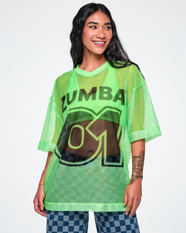 A female model wearing a green mesh Zumba top with a large black 