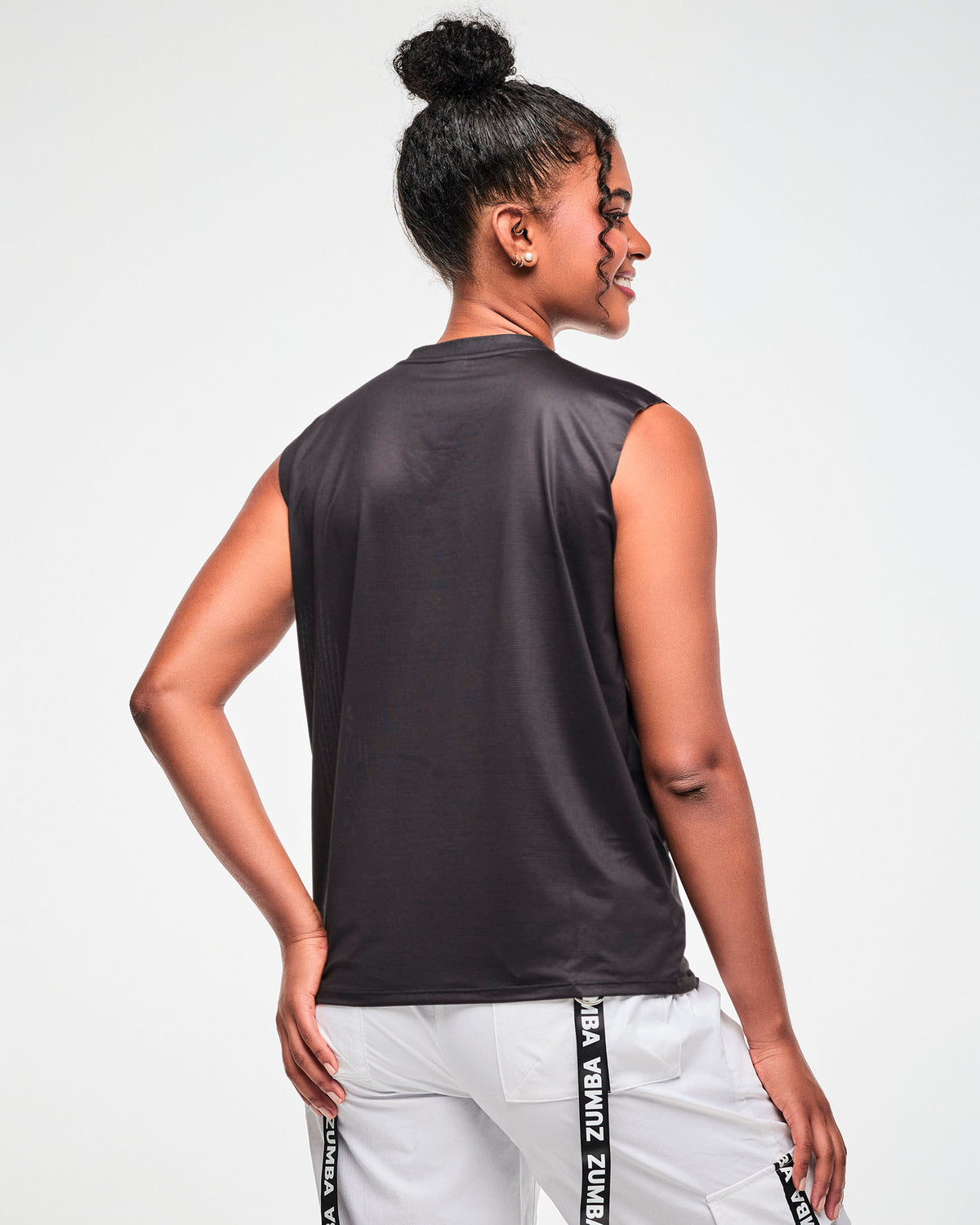 Back view of the black sleeveless muscle tee, female model, showing the relaxed fit from behind.
