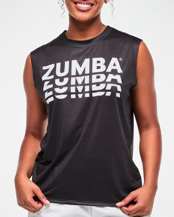 Close-up of the black sleeveless muscle tee's stacked white 'ZUMBA' print, female model.