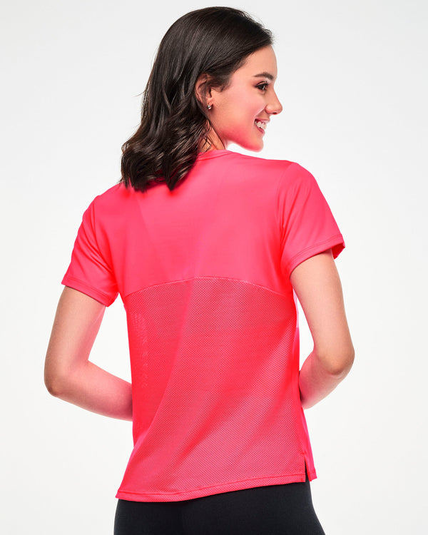 Female model wearing a pink tee with a mesh back panel, shown from the back.