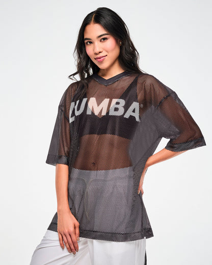 Black mesh oversized top with white 'ZUMBA' text, worn by a female model with one hand on her hip over white pants.