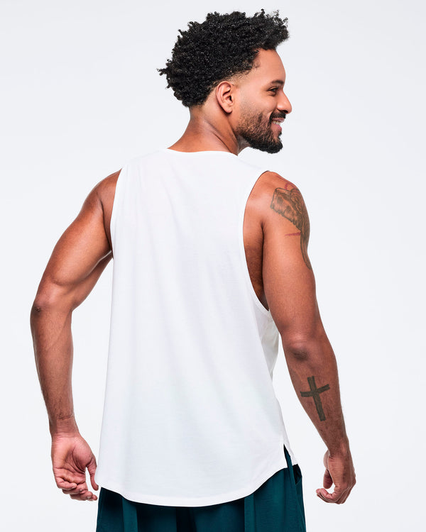 Back view of the white racerback tank on a male model, showing the plain back and deep armholes, paired with teal pants.