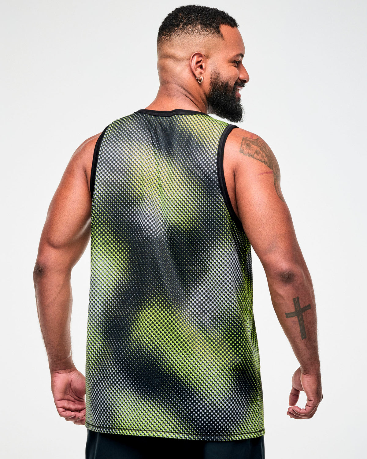Shown from the back, male model wearing a black and yellow halftone dot-print tank top.