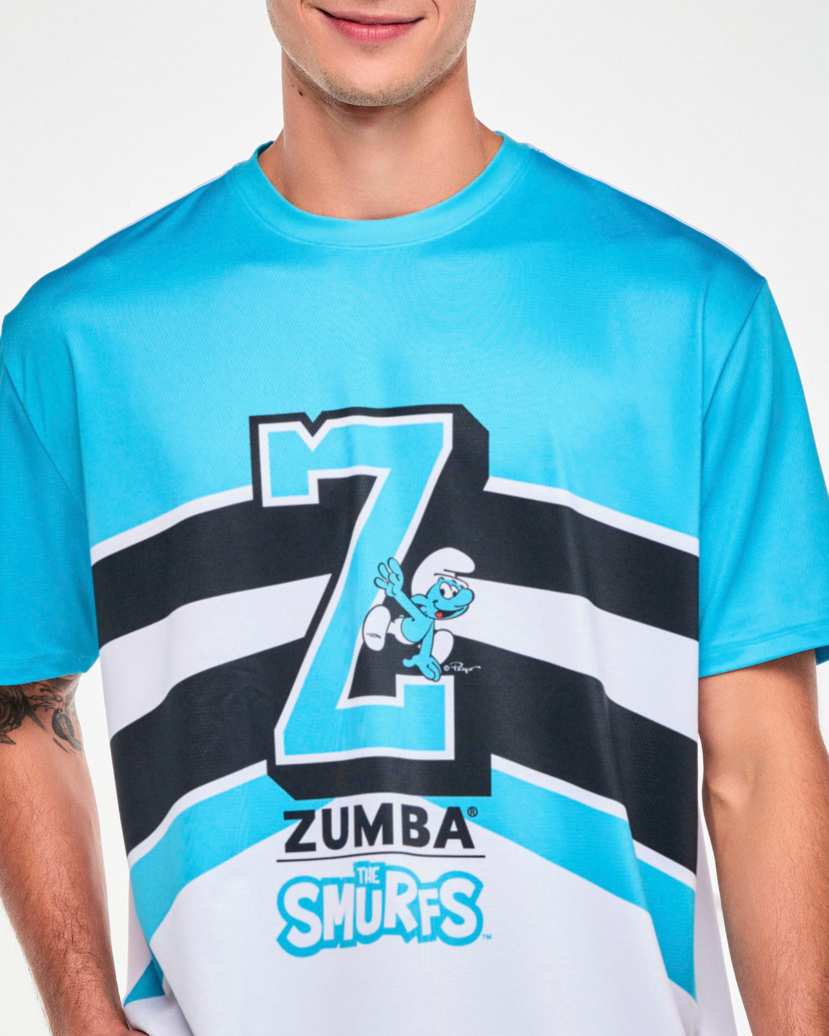 Close-up of the blue and white mesh top's front graphic, showing the Smurf climbing on the varsity 'Z' and the textured mesh fabric.