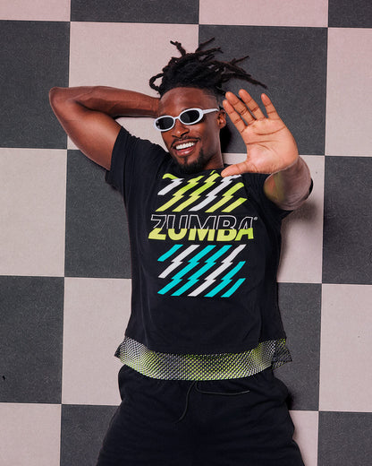 Male model in a black lightning-graphic tee with a mesh hem and black track pants, striking a playful "talk to the hand" pose on a checkered floor.