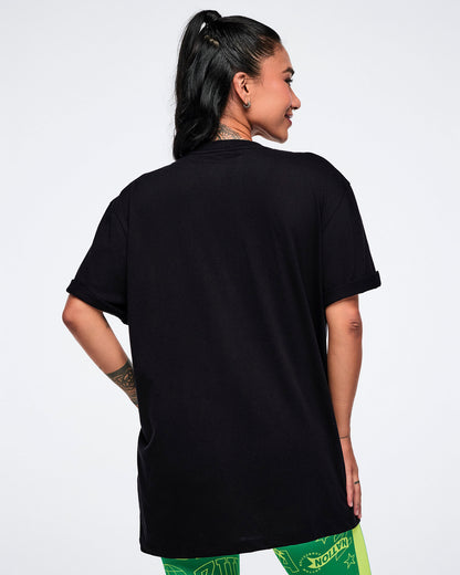 Female model showing the back view of   a black t-shirt on a white background.