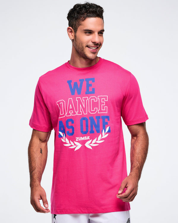 Male model wearing a pink Zumba t-shirt with 'We Dance As One' text on a white background.