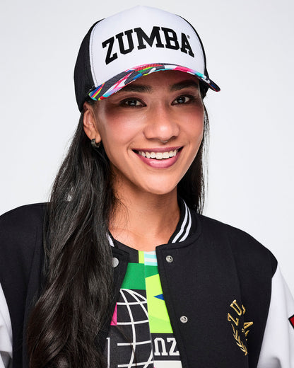 Female model wearing a Zumba cap with a colorful design on a white background.