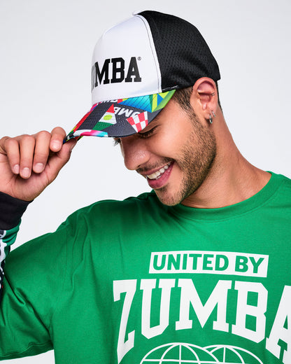 Male model wearing a colorful Zumba cap and green shirt with 'United By Zumba' text.