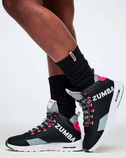Zumba shoes worn with black socks on a white background.