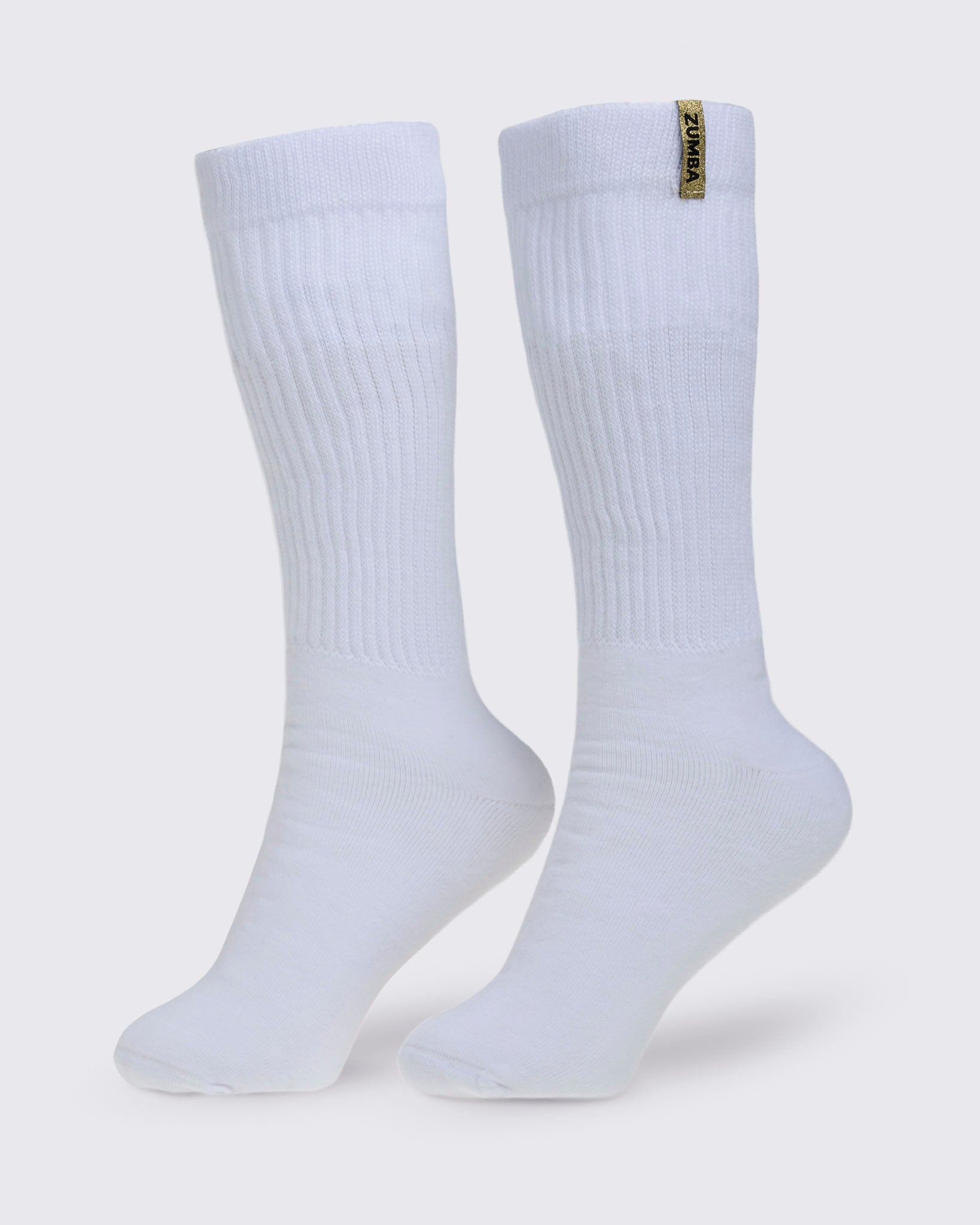 Pair of white socks with a gold Zumba logo on a white background.