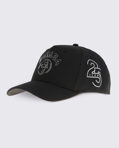 Black baseball cap with curved brim, silver Zumba logo on the front, and a silver 25 Years graphic on the side, shown at a front angle against a light gray background.