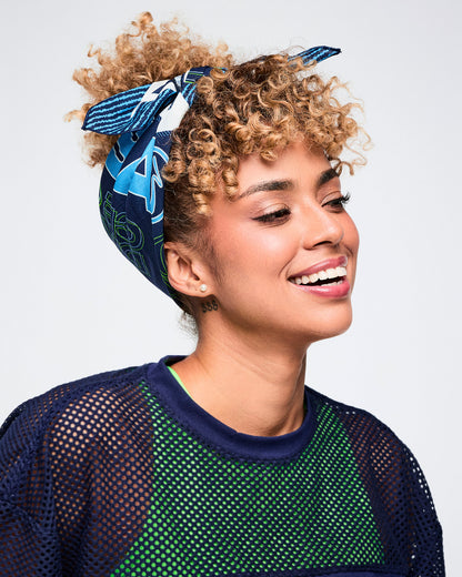 Female model styling a blue bandana as a headscarf.