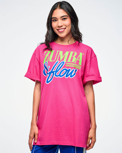 Female model wearing a pink Zumba shirt with colorful text on a white background.