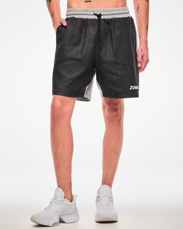 Close-up of a male model wearing black and grey shorts with a cinched drawstring waist and white 
