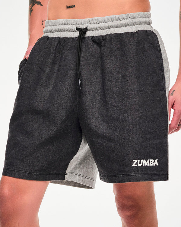 Male model wearing black denim and grey shorts with a drawstring waist, white 