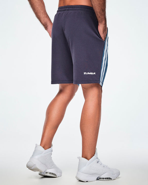 Back view of a male model wearing navy combo shorts with white 