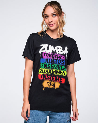 Female model wearing a black t-shirt with colorful 'Zumba' text design on a white background.