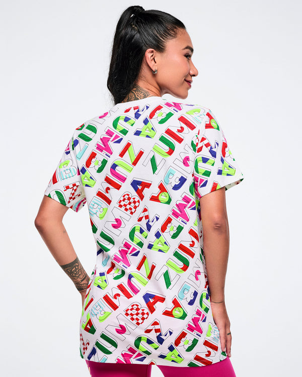 Back view of a female model wearing a colorful patterned shirt on a white background.