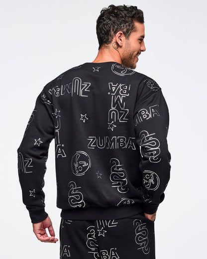 Black Zumba sweatshirt shown from the back with an allover silver logo, star, and icon print. Male model is turned away and wearing the long-sleeve crewneck sweatshirt with matching black printed joggers.