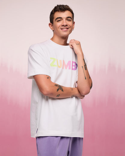 Male model wearing a white t-shirt with 'Zumba' text on a pink gradient background.