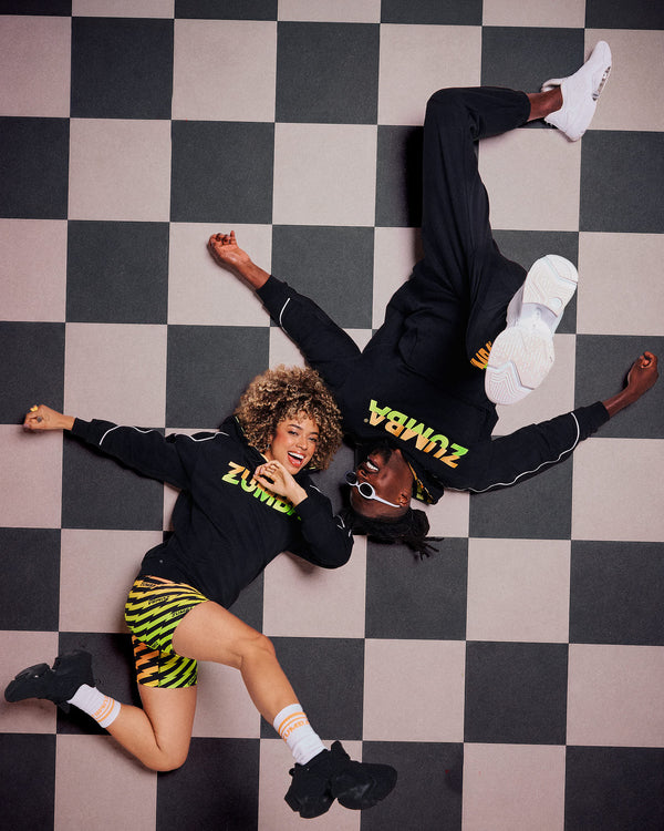 Male and female models wearing black hoodies with a gradient 