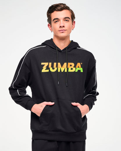 Close-up of a male model wearing a black hoodie with a gradient "ZUMBA" logo, shown with hands in the kangaroo hoodie pocket.
