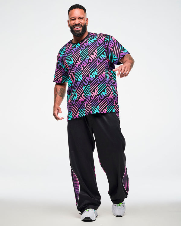 Male model wearing a black tee with a pink, aqua, and purple diagonal striped 