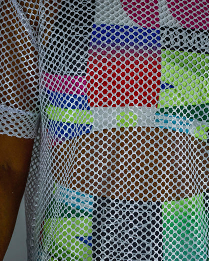 Close view of the silver mesh top with multicolored patterns of an outfit underneath.