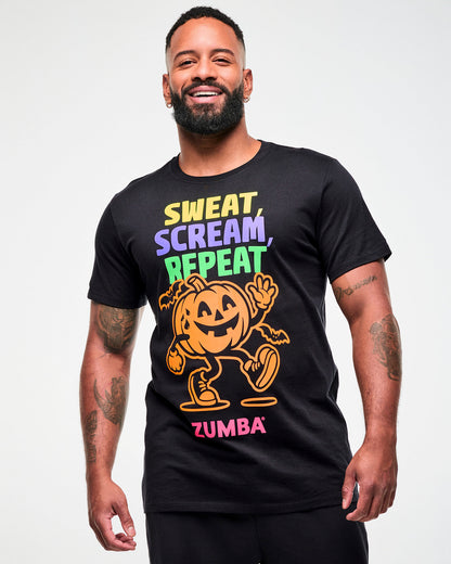 Male model wearing a black graphic tee with a colorful "Sweat, Scream, Repeat" print and a dancing pumpkin character.